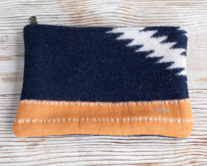 Navy and orange pouch with a white pattern on a textured surface