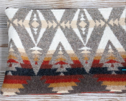 Decorative pillow with geometric pattern on a wooden surface