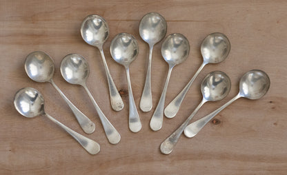 Set of silver spoons on a wooden surface