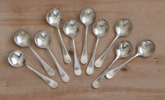 Set of silver spoons on a wooden surface