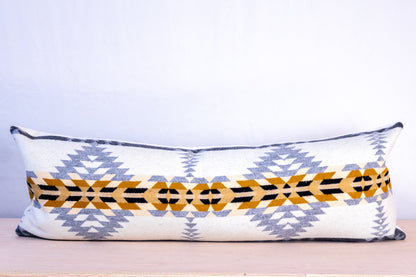 Decorative pillow with geometric pattern on a light background