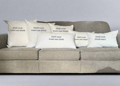 Gray sofa with decorative pillows of various sizes in a living room setting.