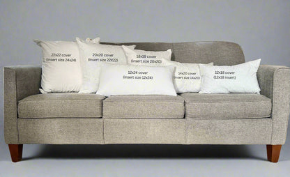 Gray sofa with white pillows displaying text about cover sizes.