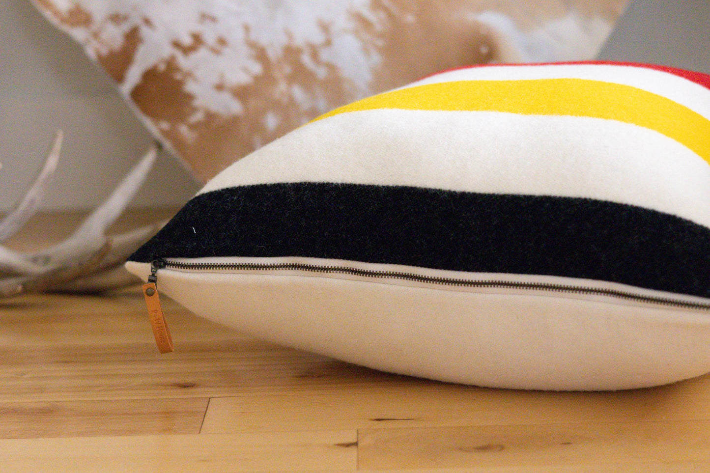 Decorative pillow with striped pattern on a wooden floor