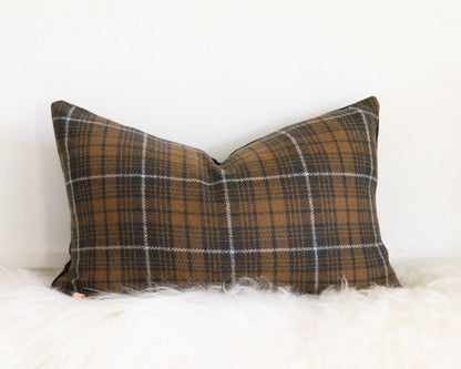 Plaid pillow on a white surface
