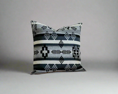 Decorative pillow with geometric pattern on a wooden surface