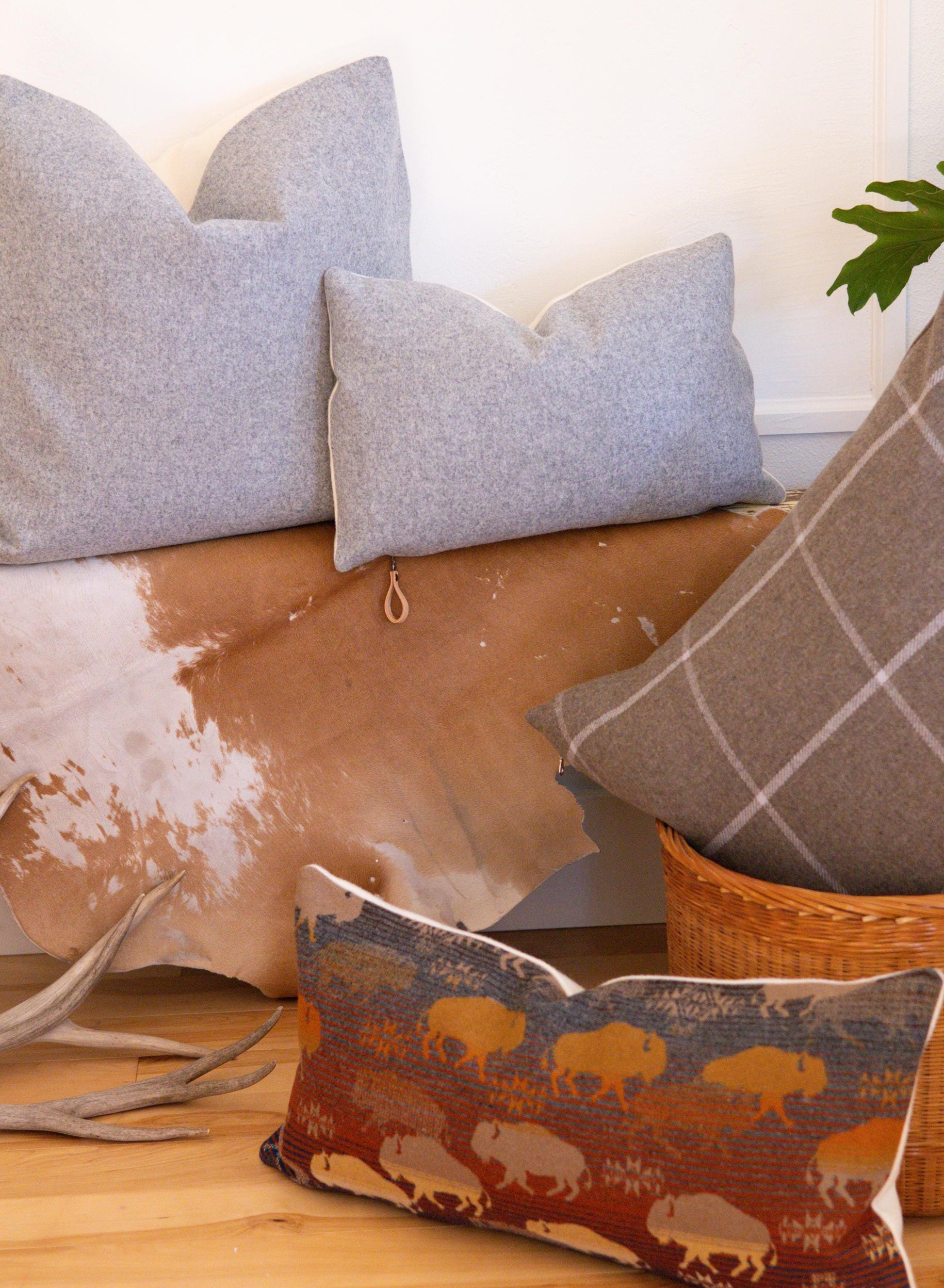 Decorative pillows on a couch with a patterned pillow featuring bison.