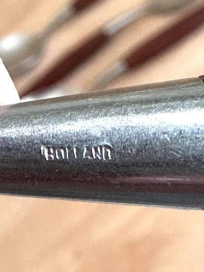 Metal rod with 'Holland' branding on a blurred background